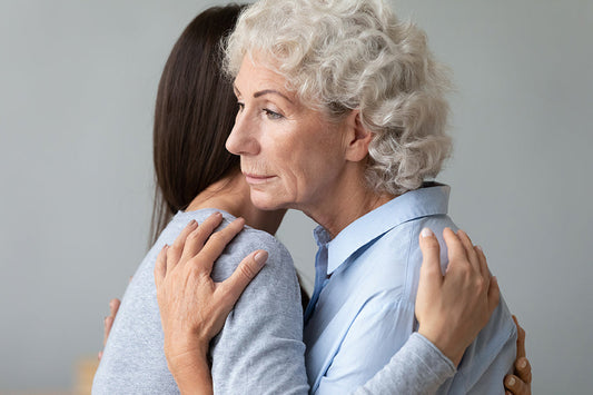 An older woman embracing a younger woman