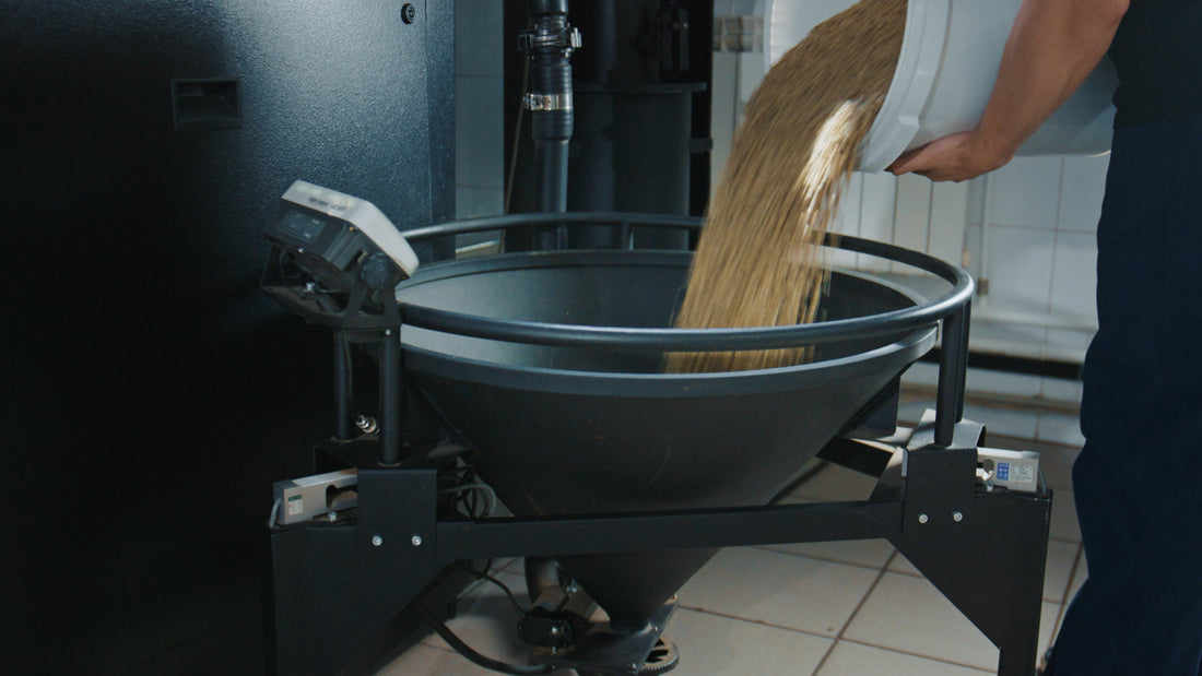 worker pouring ingredients into hopper