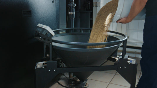 worker pouring ingredients into hopper